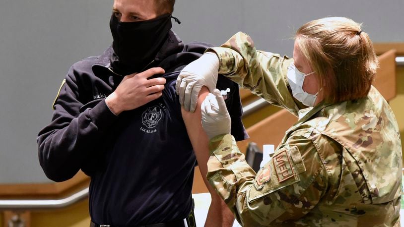 Luke Rhoades, 788th Engineer Group firefighter, receives the COVID-19 vaccine from Capt. Erica Eyer, 88MDG, flight commander, Aerospace Operational Medicine Clinic, at Wright-Patterson Air Force Base on Jan. 4, 2021. (U.S. Air Force photo by Ty Greenlees)