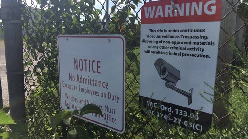 After several tons of illegal materials were found dumped and buried at West Carrollton land on Hydraulic Road in 2016, the city installed security equipment at the site and installed signs. One of those signs warn against the dumping of non-approved materials. NICK BLIZZARD/STAFF