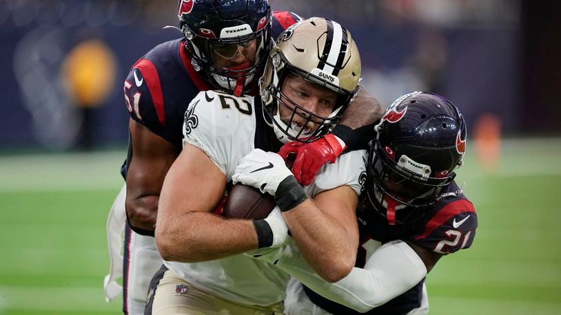 New Orleans Saints tight end Adam Trautman (82) is hit by Houston Texans linebacker Kamu Grugier-Hill (51) and cornerback Steven Nelson (21) after a catch during the first half of an NFL preseason football game Saturday, Aug. 13, 2022, in Houston. (AP Photo/David J. Phillip)