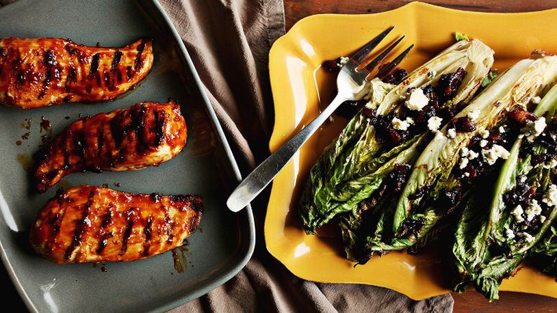 Grilled Glazed Boneless Chicken Breasts, left, and Grilled Romaine with Bacon-Blue Cheese Vinaigrette are great recipes for the summer grill. (Juli Leonard/Raleigh News & Observer/TNS)
