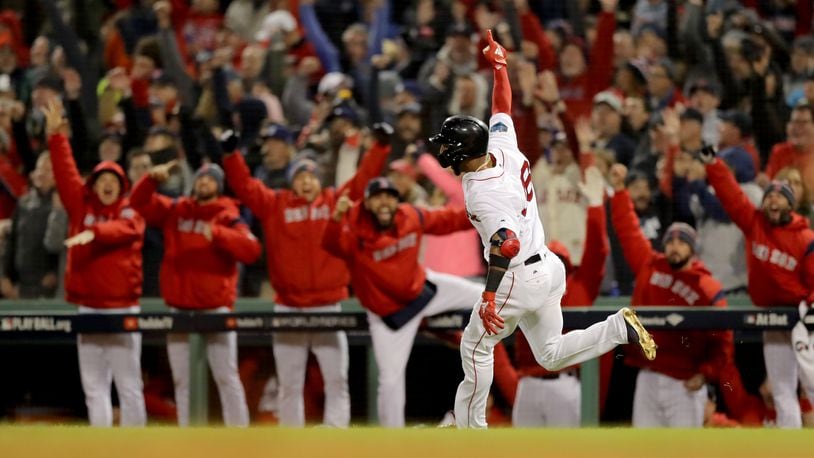 The dugout reacts as Eduardo Nunez #36 of the Boston Red Sox celebrates his three-run home run during the seventh inning against the Los Angeles Dodgers in Game One of the 2018 World Series at Fenway Park on October 23, 2018 in Boston, Massachusetts.  (Photo by Elsa/Getty Images)