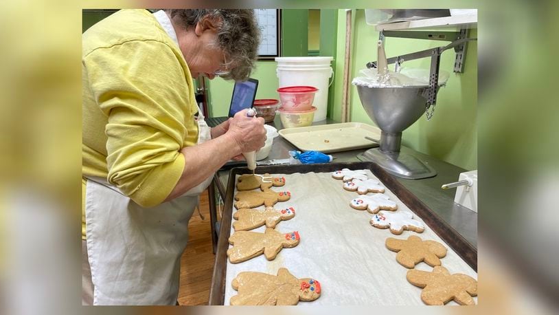 Rosemary Evans decorates gingerbread cookies at Evans Bakery, located at 700 Troy St. in the Old North Dayton neighborhood.