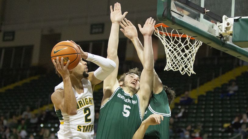 Wright State's Tanner Holden scores over Green Bay's Lucas Stieber (5) and Ryan Claflin during the first half of Saturday afternoon's game at the Nutter Center. Jeff Gilbert/CONTRIBUTED