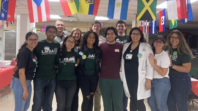 Wright State University and Boonshoft School of Medicine students are partnering to hold Latino Wellness Clinics geared toward people in the community who only or mostly speak Spanish, with the next one coming up on Dec. 9. Pictured in the first row, left to right, are Gisella Drouet, Ankur Parekh, Deborah Lee, Sade Fayiga, Ian Pabon Gonazalez, Dr. Ruth Claros, Catherine Hernandez Hogan, and Enedina Sepulveda Martinez. In the second row are Will Bohne, Sam Doehring, Steffen Fallini, and Kevin Williams. PROVIDED