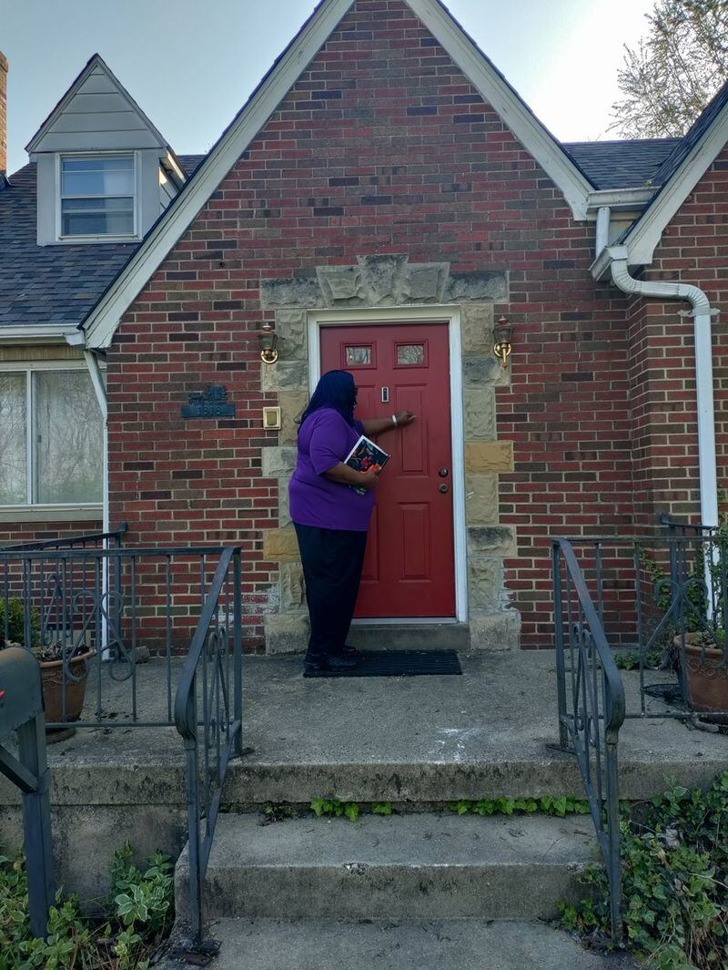 Tobette Pleasant-Brown, a truant officer for Dayton Public Schools, visiting a student’s home. (CONTRIBUTED PHOTO)