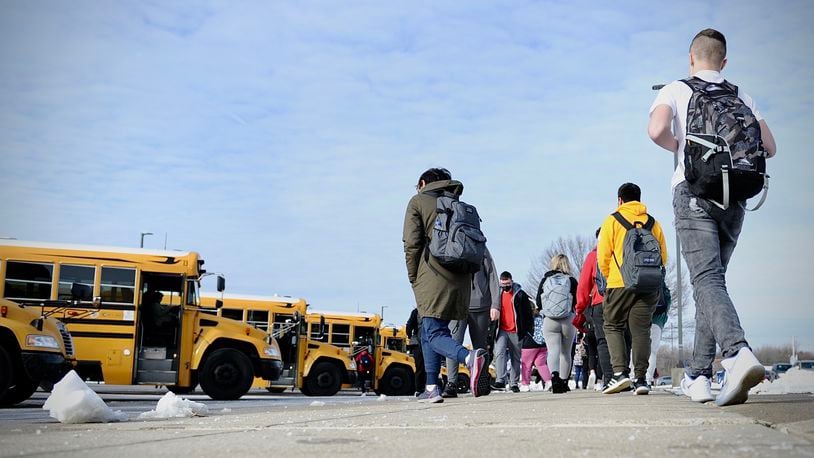 Stebbins High School students prepare to board buses after returning to school Tuesday, Jan. 18, 2022. The Mad River school district had been doing online learning the previous few school days amid many COVID cases. MARSHALL GORBY \STAFF