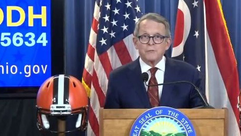 Ohio Gov. Mike DeWine had football helmets representing the state’s two NFL teams on either side of the dais during a daily press conference on the coronavirus situation Thursday, April 23, 2020. A Cleveland Browns helmet was to his right, and a Cincinnati Bengals helmet was to his left. The NFL draft was to begin Thursday evening.