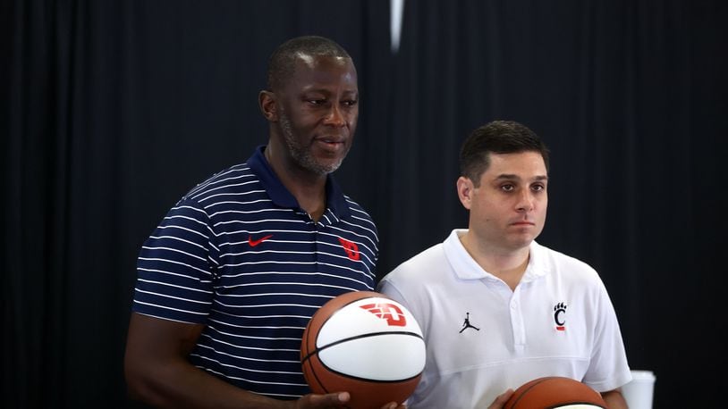 Dayton coach Anthony Grant and Cincinnati coach Wes Miller pose for a photo at a press conference where the Hoops Classic game between UD and Cincinnati was announced on Wednesday, July 19, 2023, at the Heritage Bank Center in Cincinnati. The Flyers and Bearcats will play at the arena on Dec. 16. David Jablonski/Staff