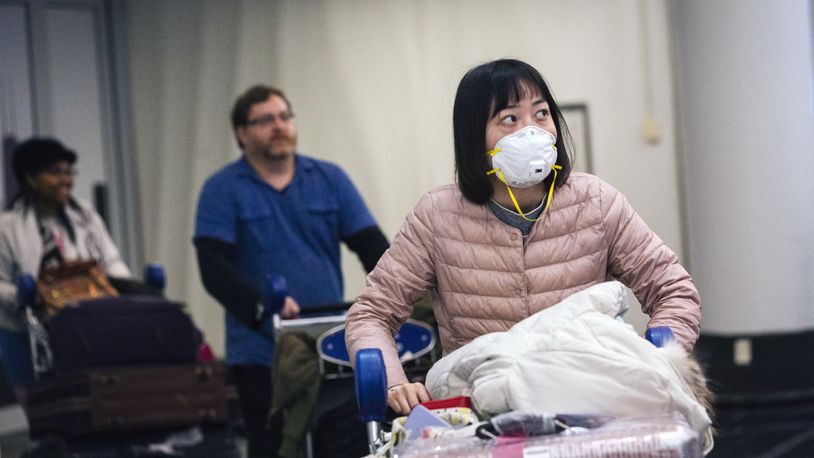 Travelers arrive at OHare International Airport in Chicago. Health officials around the country are struggling to keep up with costs of screening passengers from China and other parts of the world. (Taylor Glascock/The New York Times)