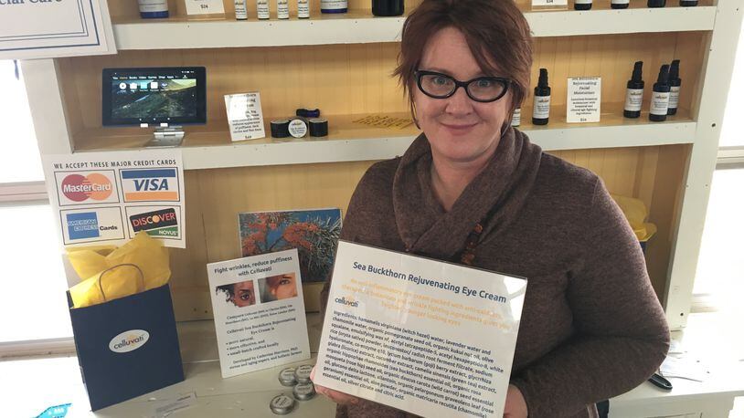Dr. Catherine Harrison pictured here with the ingredient list of her Sea Buckthorn Rejuvenating Eye Cream.
