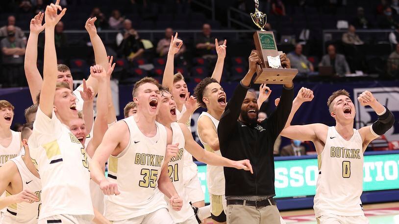 The Botkins High School boys basketball team celebrates a 60-44 win over Columbus Grove 60-44 in the Division IV state championship game at UD Arena on Sunday, March 21, 2021. It's the first boys basketball state title in school history. Michael Cooper/CONTRIBUTED