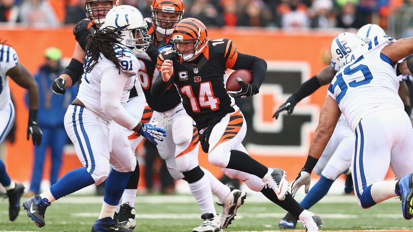 CINCINNATI, OH - DECEMBER 08: Andy Dalton #14 of the Cincinnati Bengals runs with the ball during the NFL game against the Indianapolis Colts at Paul Brown Stadium on December 8, 2013 in Cincinnati, Ohio. (Photo by Andy Lyons/Getty Images)