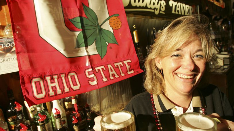 Dee Cronkhite, manager of Clancy's Tavern at 5514 Burkhardt Road, serves beer during Ohio State football games. STAFF FILE