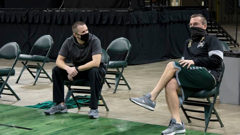 Wright State athletic trainer Jason Franklin (right) and Cole Pittsford, the Raiders' strength and conditioning coach, during practice Friday at the Nutter Center. CONTRIBUTED