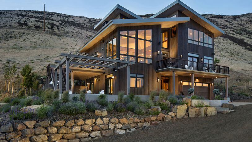 “The exterior design and materials were chosen to have the building appear as a basalt rock outcrop, which are extensive throughout the Yakima Canyon,” says homeowner Mark Kane. “Vertical cedar siding, pretty much all natural stone, granite stairs, Glulam beams, fir trim.” (Steve Ringman/Seattle Times/TNS)