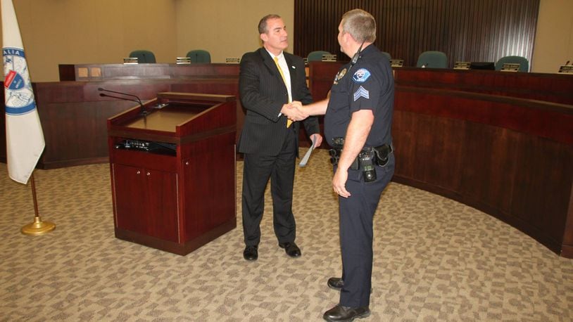 City Manager John Crusey congratulations Officer Lawson