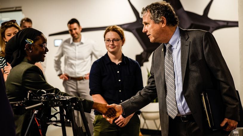 Ohio Senator Sherrod Brown shakes the hand  of Wright Brothers Institute intern, Nene Bah at the institute Tuesday June 29, 2021. Brown was touring the facility. JIM NOELKER/STAFF