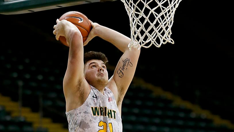 Wright State forward Grant Basile attempts a dunk but bounces the ball off the rim against Milwaukee during a Horizon League quarterfinal at the Nutter Center in Fairborn Mar. 2, 2021. Basaile on Monday was named Horizon League Player of the Week. The Raiders travel to No. 6 Purdue on Tuesday night. DAYTON DAILY NEWS FILE