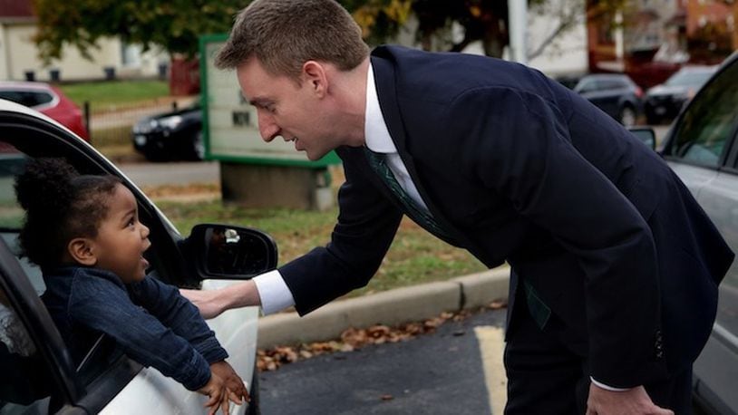 Democratic candidate for U.S. Senate Jason Kander talks with Teh'Riyah Hinkel, 1, after thanking her aunt for coming out to vote on November 8, 2016, in St. Louis. (Laurie Skrivan/St. Louis Post-Dispatch/TNS)