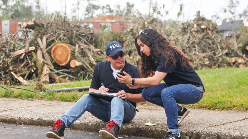Steve Cooper and Malyssa Suarez, both with the Federal Emergency Management Agency, conduct a joint preliminary assessment of tornado-damage Wednesday at the Westbrooke Village Apartments in Trotwood. CHRIS STEWART / STAFF