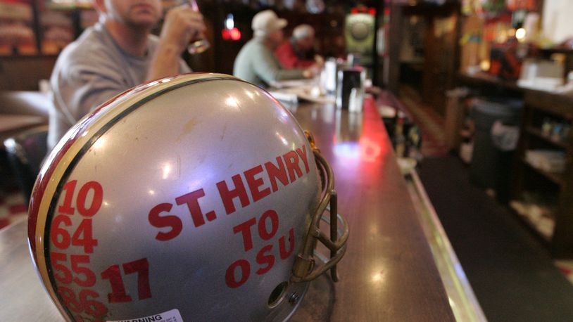 31 Oct 07 Photo by Ron Alvey. A football helmet, on the bar at Fish-Mo’s, is adorned with numbers of St. Henry High School football players that went on to play for The Ohio State Buckeyes. Fish-Mo’s is a sports bar in St. Henry Ohio. Todd Boeckman’s, the Buckeye quarterback and a graduate of St. Henry, wears the number 17.