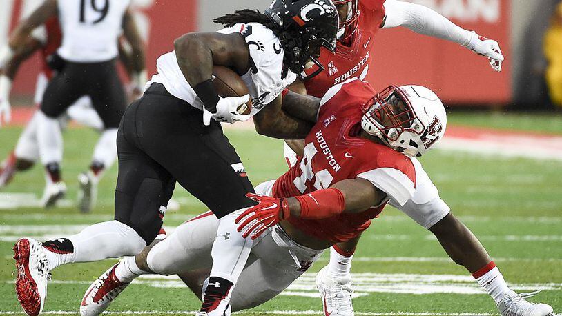 HOUSTON, TX - NOVEMBER 7: Mike Boone #5 of the Cincinnati Bearcats pushes away Elandon Roberts #44 of the Houston Cougars in the third quarter of a NCAA football game at TDECU Stadium on November 7, 2015 in Houston, Texas. (Photo by Eric Christian Smith/Getty Images)