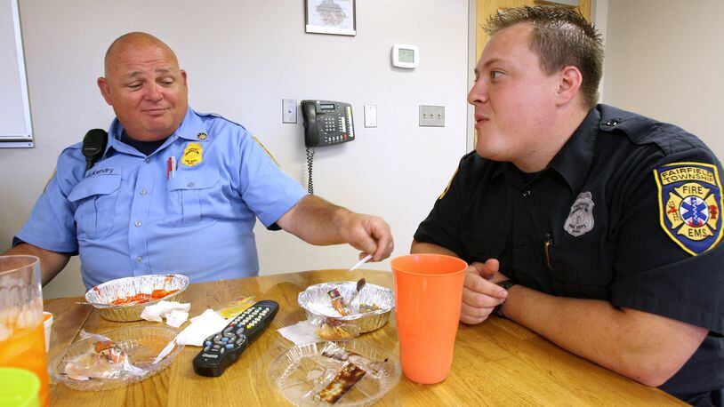 Fairfield Twp. trustees voted 2-1 against a petition by residents seeking to re-name the park at Millikin and Morris roads after the former township assistant fire chief Paul McKendry, who died in February 2009. McKendry, at left, is pictured eating lunch with firefighter Jody Asher in September 2007 at the Fairfield Twp. Fire Headquarters. FILE PHOTO/2007