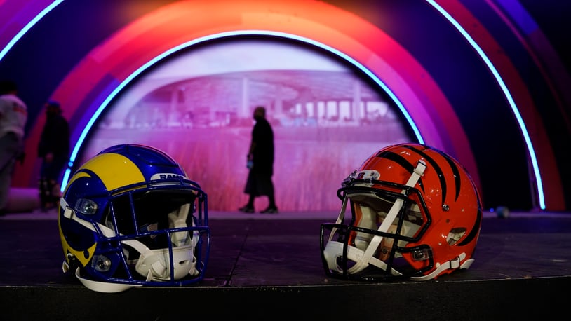 Los Angeles Rams and Cincinnati Bengals helmets rest on a stage inside the NFL Experience, an interactive fan show, Friday, Feb. 4, 2022, at the Los Angeles Convention Center in Los Angeles. The Los Angeles Rams are scheduled to play the Cincinnati Bengals in the Super Bowl NFL football game Feb. 13 in Inglewood, Calif. (AP Photo/Marcio Jose Sanchez)