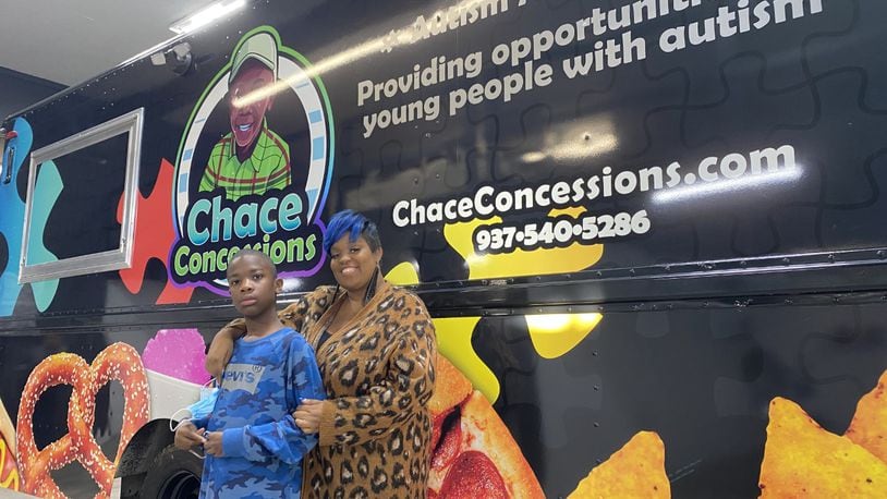 Dayton entrepreneur Tae Winston (right) gifted a food truck to her 11-year-old son, Chace, who has autism. The truck, which was presented to the boy at Performance Wraps in Miamisburg Monday, Dec. 13, 2021. It will employ people with autism, raising awareness of the developmental disorder and raising funds for the Dayton Autism Society. ERIC SCHWARTZBERG/STAFF