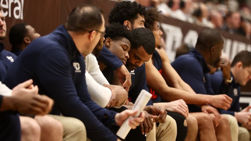Dayton's Ricardo Greer comforts Malachi Smith after he suffered an injury in the second half against St. Bonaventure on Saturday, Feb. 4, 2023, at the Reilly Center in St. Bonaventure, N.Y. David Jablonski/Staff