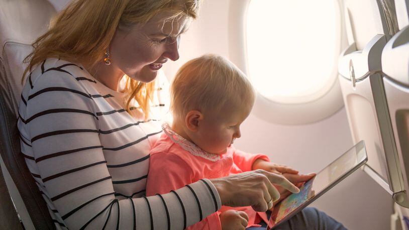 Experts say the safest place for a child on an airplane is in a safety seat and not on a lap. (Kaspars Grinvalds/Dreamstime/TNS)