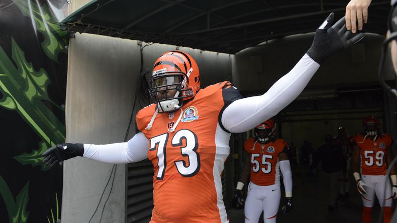 Cincinnati Bengals tackle Anthony Collins (73) runs onto the field at the start of an NFL football game against the Dallas Cowboys, Sunday, Dec. 9, 2012, in Cincinnati. (AP Photo/Michael Keating)