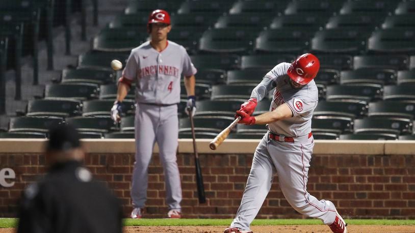 Cincinnati Reds' Mike Moustakas (9) hits three-run home run against the Chicago Cubs during the first inning of a baseball game Wednesday, Sept. 9, 2020, in Chicago. (AP Photo/Kamil Krzaczynski)