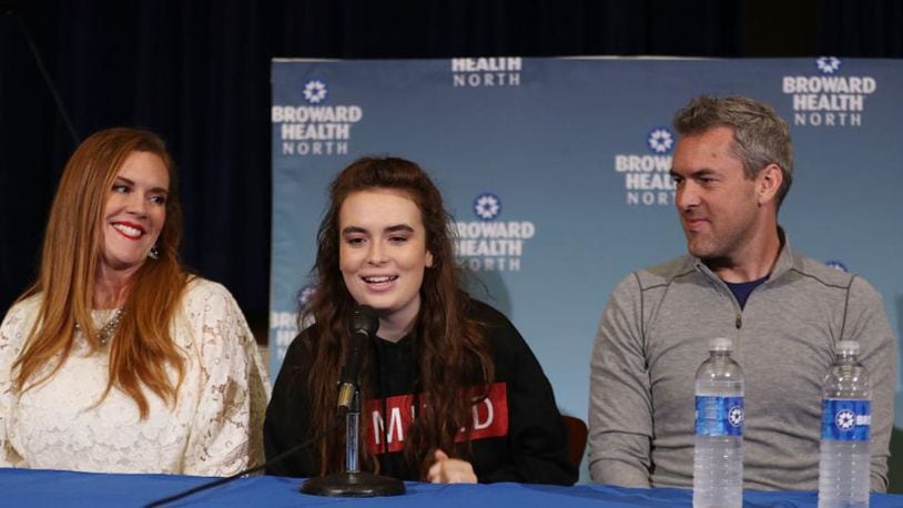Maddy  Wilford is flaned by her parents, Missy Wilford and David Wilford, as she speaks to the media at Broward Health North where she was treated after being shot multiple times during the mass shooting at Marjory Stoneman Douglas High School.