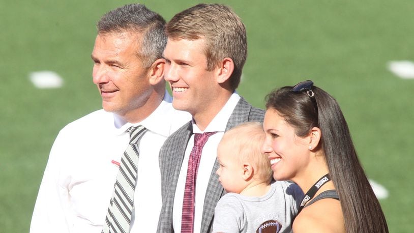 Ohio StateÃ­s Urban Meyer poses for a photo with son-in-law Corey Dennis, grandson Troy and daughter Nicki Meyer Dennis after arriving at Ohio Stadium before a game against UNLV  on Saturday, Sept. 23, 2017, in Columbus. David Jablonski/Staff
