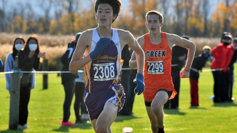 Bellbrook's Takumi Ford (left), Beavercreek's Connor Ewert (right) during Saturday's Division I district cross country meet at Cedarville. Greg Billing/CONTRIBUTED