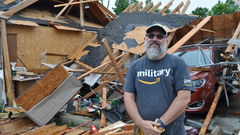 Mike Roberts of Charlie Court in Brookville stands in front of his garage that was destroyed by a tornado late Monday night. An EF 3 tornado tore through Brookville as part of a 13 tornado outbreak on Memorial Day.