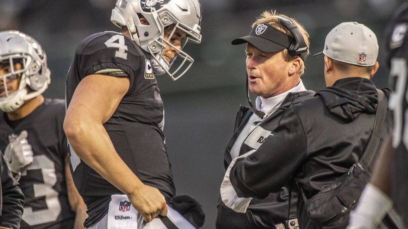 Oakland Raiders quarterback Derek Carr (4) talks with Oakland Raiders head coach Jon Gruden during the second half against the Pittsburgh Steelers on Sunday, Dec. 9, 2018 at the Oakland-Alameda County Coliseum in Oakland, Calif. (Hector Amezcua/Sacramento Bee/TNS)
