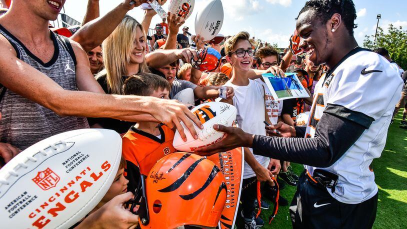 Wide receiver John Ross signs autographs during the first day of Cincinnati Bengals Training Camp Friday, July 28 at the practice fields beside Paul Brown Stadium in Cincinnati. NICK GRAHAM/STAFF