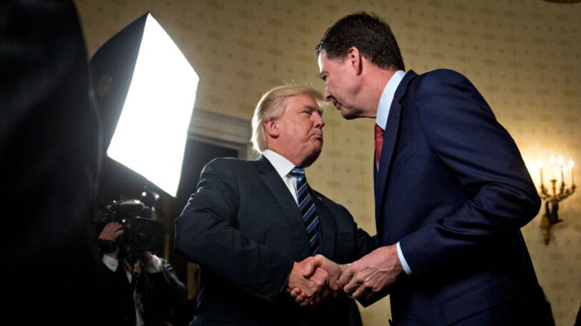 WASHINGTON, DC - JANUARY 22: U.S. President Donald Trump, left, shakes hands with James Comey, director of the Federal Bureau of Investigation (FBI), during an Inaugural Law Enforcement Officers and First Responders Reception in the Blue Room of the White House on January 22, 2017 in Washington, D.C. Trump on June 16 lashed out at the Justice Department official with authority over the special counsel probe of Russian election-meddling, and acknowledged that his firing of Comey as FBI director is a focus of the investigation. Photo by Andrew Harrer-Pool/Getty Images)