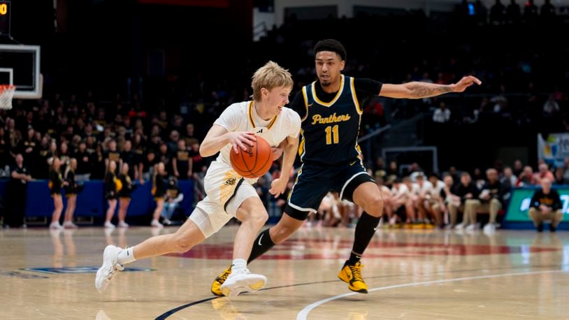 Centerville's Cohen Ellis drives toward the basket against Toledo Whitmer's Elijah McLeod during the first half of Saturday night's state semifinal victory at UD Arena. Logan Howard/CONTRIBUTED