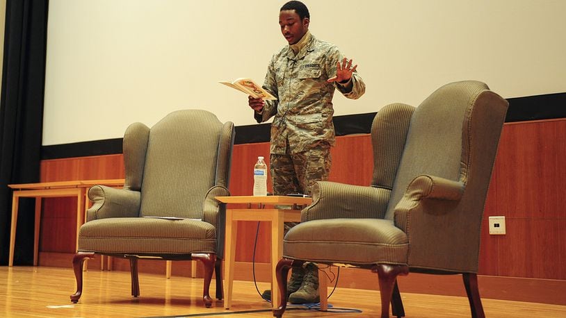 Senior Airman Yahel Pack, a geospatial analyst working in the National Air and Space Intelligence Center, performs his poetry in the NASIC auditorium before his peers. (U.S. Air Force photo/Senior Airman Samuel Earick)