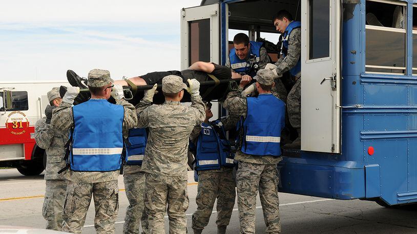 Wright-Patterson Air Force Base first responders load a volunteer “victim” onto a vehicle for emergency transport during a May 2013 tornado exercise. Response action is expected of all personnel during the March 31 base-wide drill. U.S. AIR FORCE PHOTO/MIKE LIBECAP