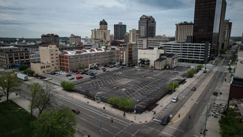 A city of Dayton-owned parking lot on the south side of East Second Street sits empty, taking up most of the land between St. Clair Street (foreground) and Jefferson Street. JIM NOELKER / STAFF