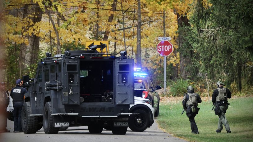 Dayton, police and swat team Montgomery county sheriffs around the house on Hacker Road after an officer was shot while serving a warrant Thursday afternoon. MARSHALL GORBY \STAFF