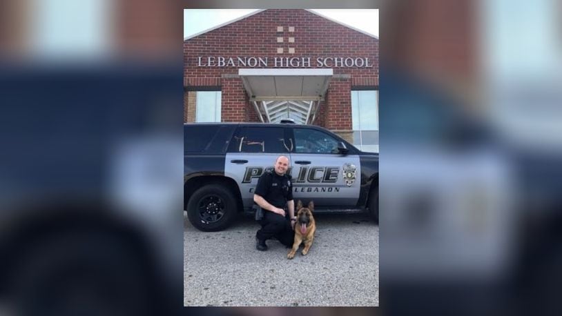 Former Lebanon Police Officer Eric Holmes and Max, a drug detection dog acquired by the school district to patrol schools, activities. Holmes resigned a few weeks ago after it was discovered that a number of traffic tickets were never filed with Lebanon Municipal Court. A Warren County grand jury declined to indict Holmes on any charges. FILE PHOTO
