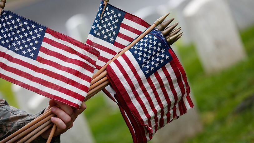 ARLINGTON, VA - MAY 21: Members of the 3rd U.S. Infantry Regiment place American flags at the graves of U.S. soldiers buried at Arlington National Cemetery, in preparation for Memorial Day May 21, 2015 in Arlington, Virginia. 'Flags-In' has become an annual ceremony since the 3rd U.S. Infantry Regiment (The Old Guard) was designated to be an Army's official ceremonial unit in 1948 (Photo by Win McNamee/Getty Images)