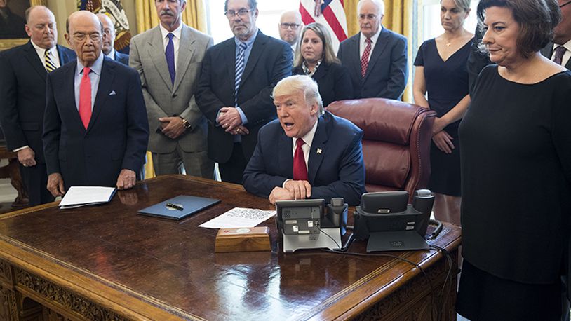 President Donald Trump signs a directive regarding steel imports and national security, related to the Trade Expansion Act of 1962, in the Oval Office of the White House, in Washington, April 20, 2017. In remarks here Thursday, Trump added a new name to the list of countries that he accuses of preying on American workers and exploiting American trade policies: Canada.