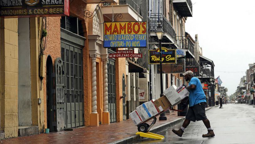 Fred Foster makes a delivery on Bourbon Street in the French Quarter Saturday in New Orleans, as Tropical Storm Barry nears landfall. (AP Photo/David J. Phillip)