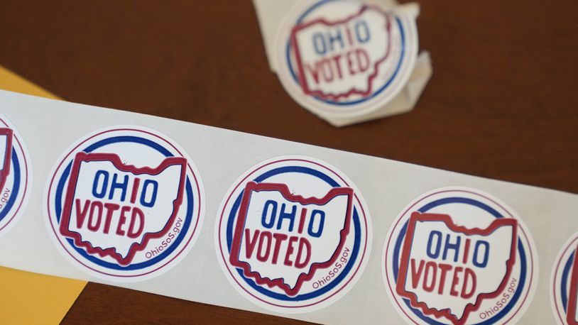 "Ohio Voted" stickers await voters after they cast their ballots at the Meadowbook Golf Club in Clayton, Ohio Tuesday, Nov. 8, 2022. (AP Photo/Michael Conroy)